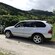 A BMW SUV parked near a lush mountain landscape